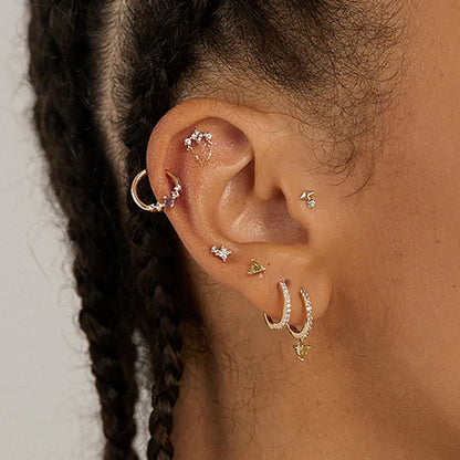 donna che indossa il piercing per orecchio con zirconi bianchi e viola per helix
