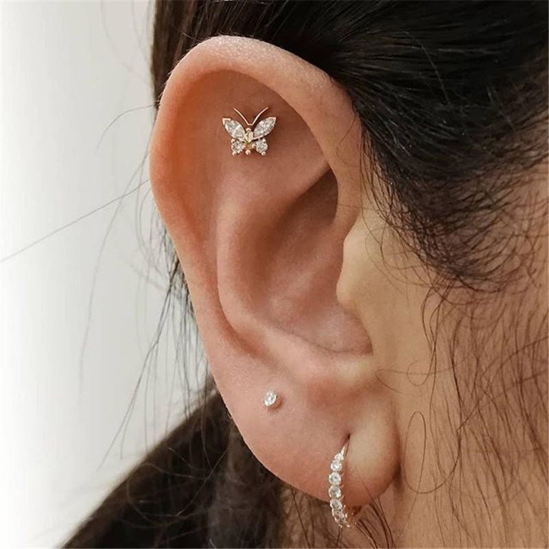 "Piercing Helix Farfalla indossato dorato, mostrando il suo effetto luminoso."